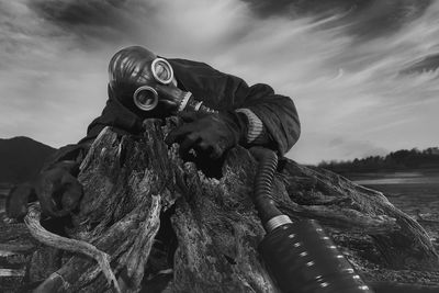 Low angle view of man with gas mask outdoors