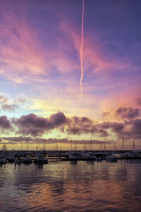 Scenic view of sea against dramatic sky during sunset