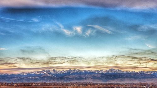 Scenic view of snowcapped mountains against sky