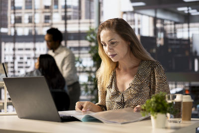 Young woman using laptop at office