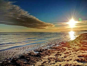 Scenic view of beach against sky during sunset