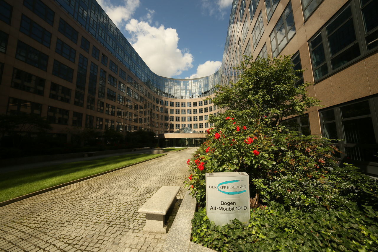 STREET AMIDST BUILDINGS AGAINST SKY