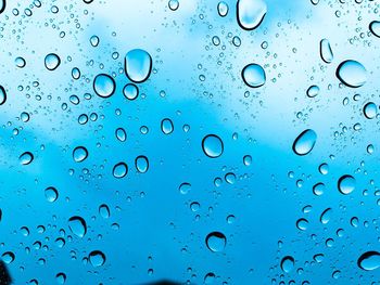 Full frame shot of raindrops on window