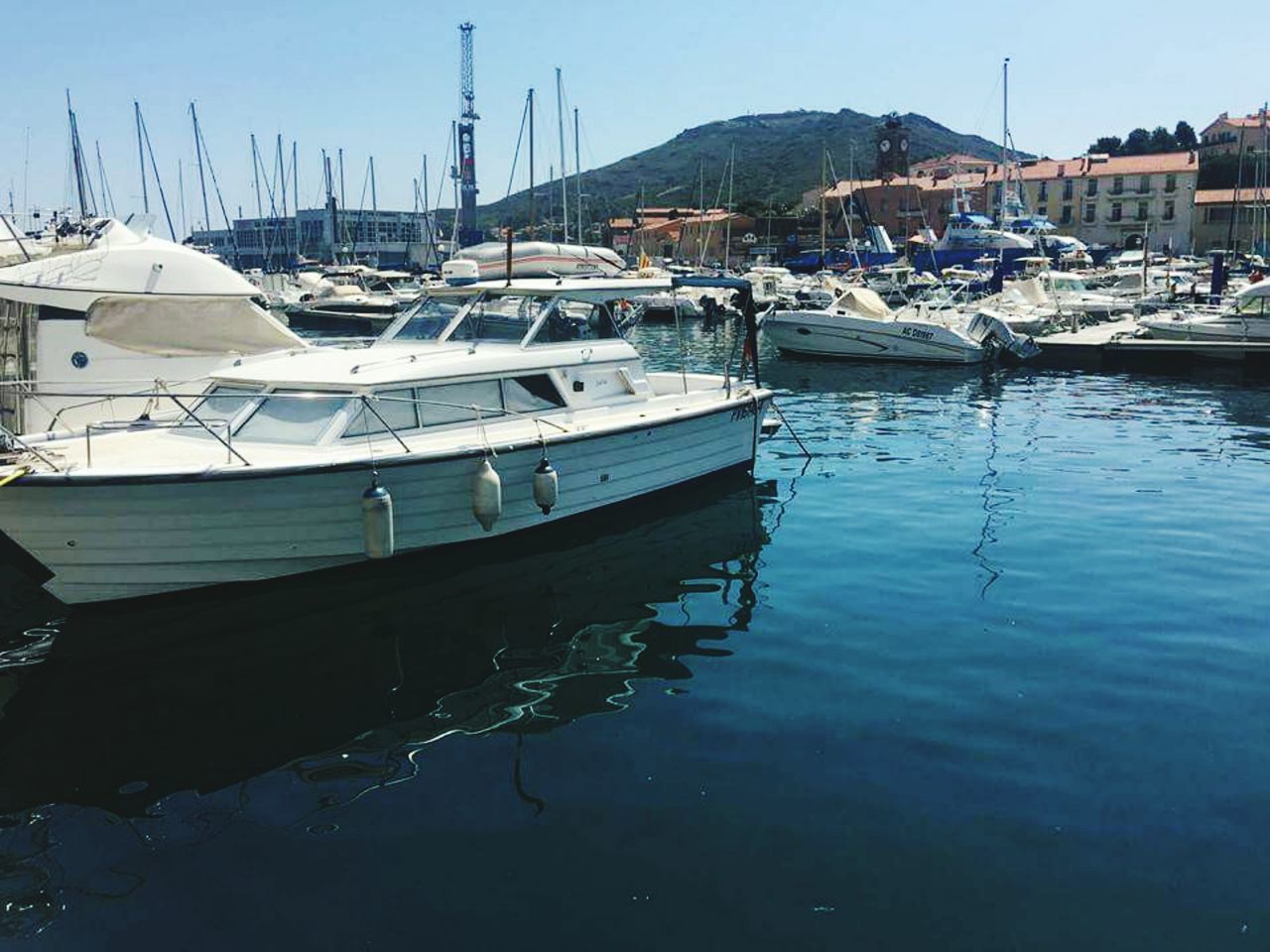 BOATS MOORED AT HARBOR