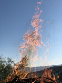 Close-up of bonfire against sky