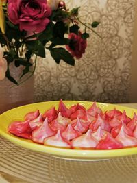 Close-up of pink roses in plate on table