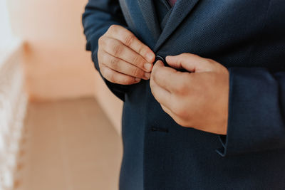 Midsection of man wearing handcuffs