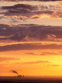 Germany, leipzig, industrial area and wind park at sunset