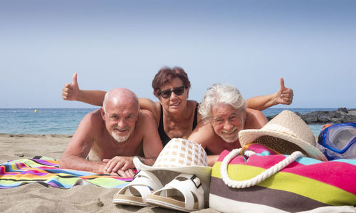 Portrait of people on beach against sky