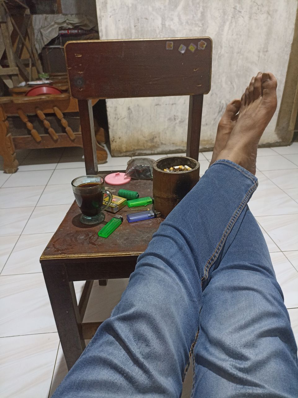 one person, human leg, low section, jeans, furniture, lifestyles, indoors, adult, personal perspective, casual clothing, table, leisure activity, high angle view, limb, relaxation, wood, sitting, shoe, human limb, flooring, clothing, barefoot, chair, seat, floor, men, human foot, art, home interior, day, women