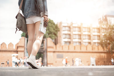 Low section of woman walking outdoors