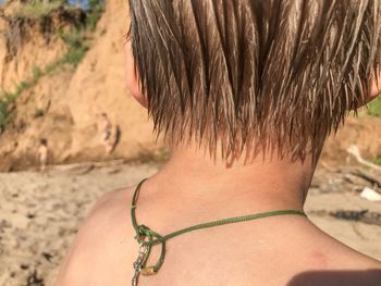 Rear view of woman with arms hair at beach