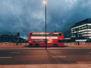 Blurred motion of train against sky in city at night