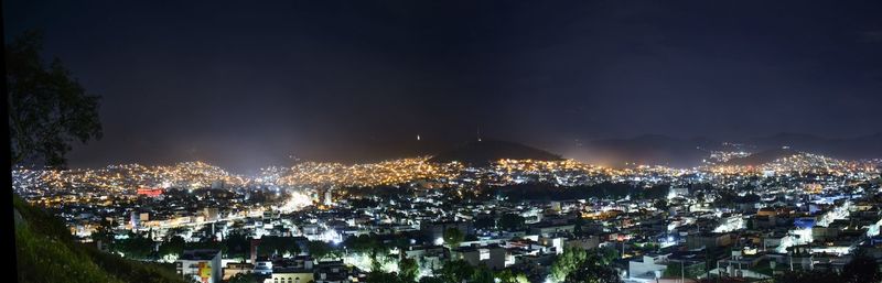 High angle view of illuminated city buildings against sky