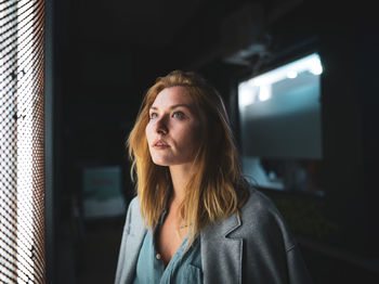 Portrait of beautiful young woman standing at home