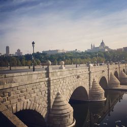 View of bridge in city against sky