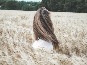 Rear view of woman in wheat field