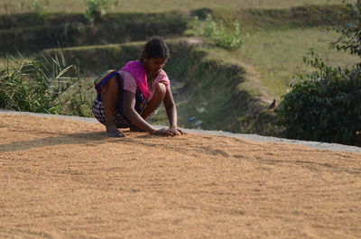 Full length of woman working on field