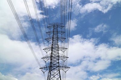 Low angle view of electricity pylon against sky