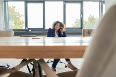 Businesswoman relaxing on chair in board room