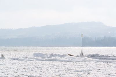 Scenic view of frozen landscape against sky