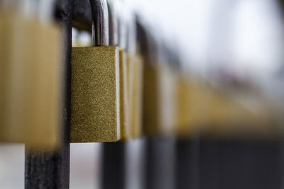 Close-up of yellow metal hanging on wood