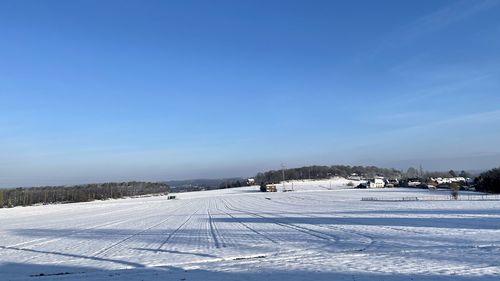 Snow covered field against sky