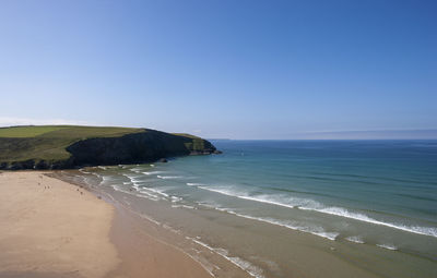 Scenic view of beach against clear blue sky