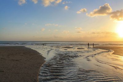 Scenic view of beach against sky during sunset