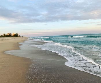 Scenic view of beach against sky during sunset