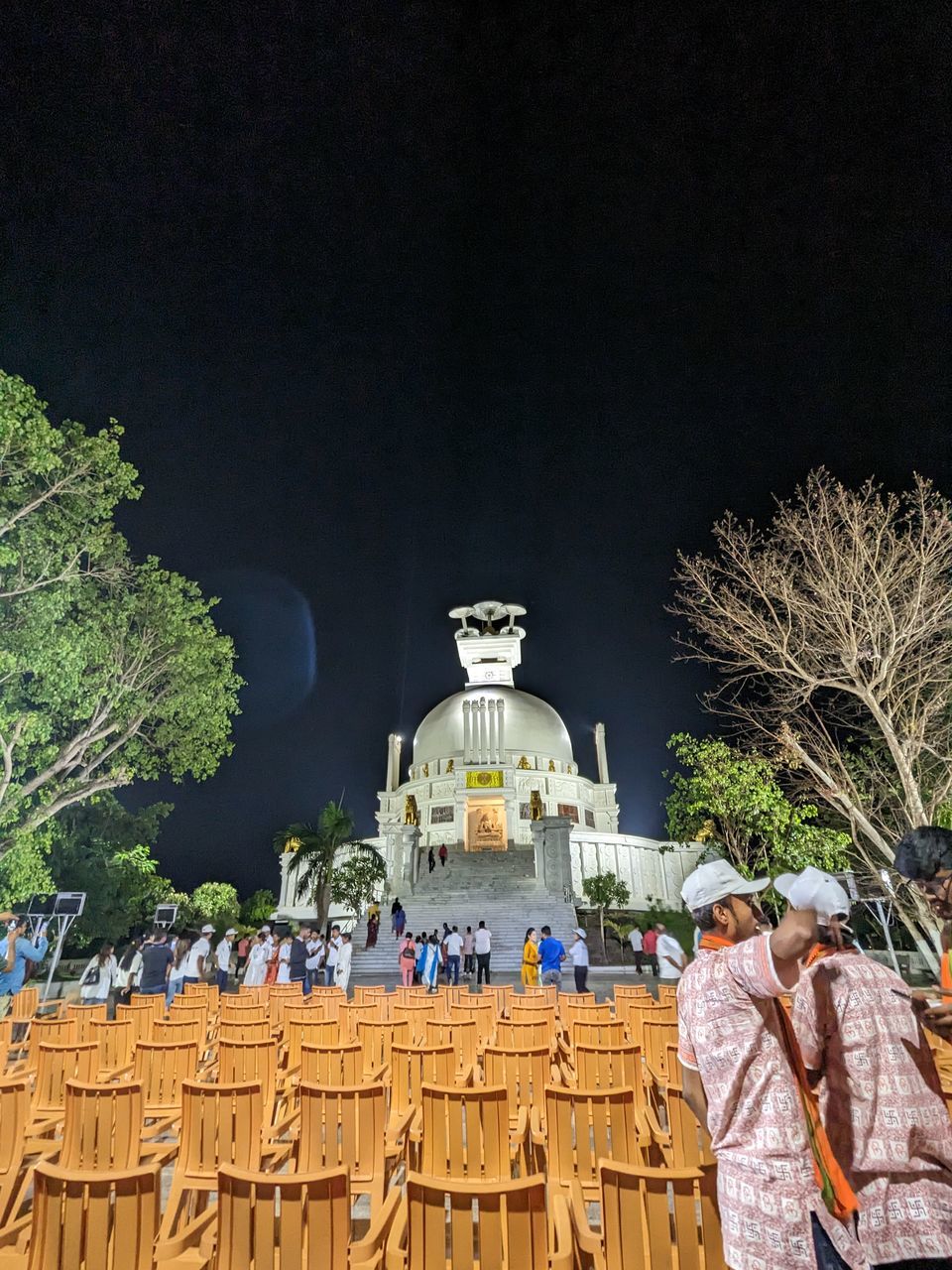 architecture, religion, tree, belief, night, nature, built structure, plant, spirituality, building exterior, place of worship, travel destinations, men, outdoors, sky, adult, history, the past, travel, clothing, tradition, building, temple - building