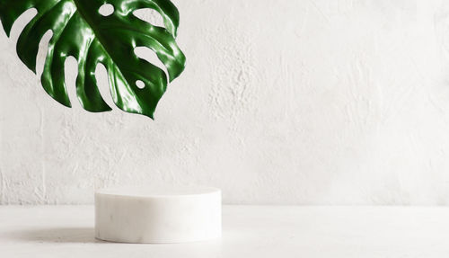 Close-up of white table against wall at home