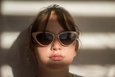 Close-up of young woman wearing sunglasses