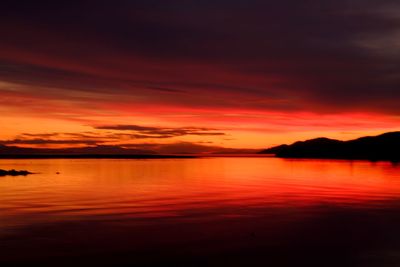 Scenic view of lake against romantic sky at sunset