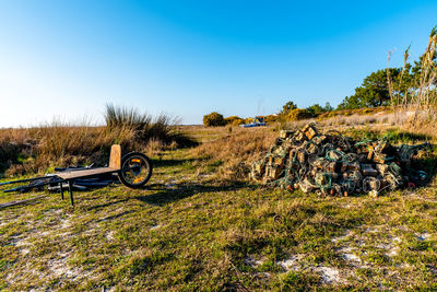 Bicycle parked on field against clear sky