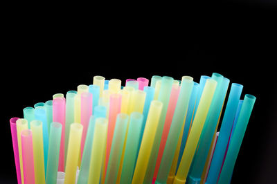 Close-up of multi colored pencils over black background