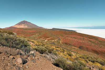 Scenic view of mountains against clear blue sky