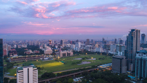 High angle view of buildings in city against sky during sunset