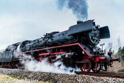 Train on railroad tracks against sky