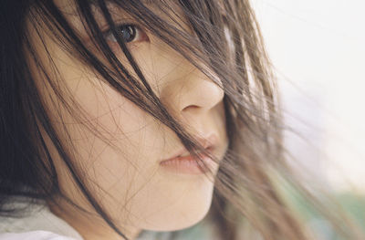 Close-up of young woman with brown hair