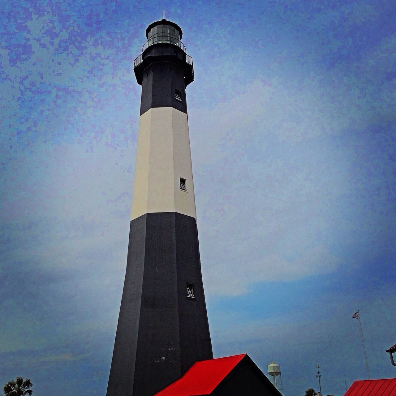 lighthouse, building exterior, architecture, built structure, guidance, tower, direction, low angle view, protection, sky, safety, security, tall - high, cloud - sky, outdoors, no people, tall, day, building, cloud