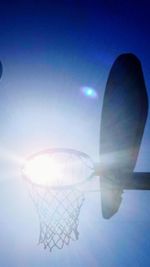 Digital composite image of hand against sky on sunny day