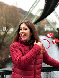 Portrait of smiling young woman standing outdoors