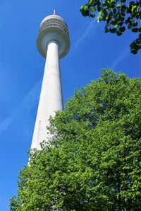 Low angle view of tower and tree against sky