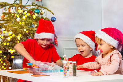 Portrait of happy family sitting on table