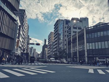 City street by buildings against sky