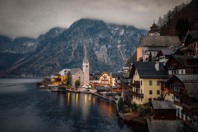 River amidst buildings in city against sky