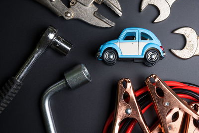 High angle view of toy car with hand tools on table