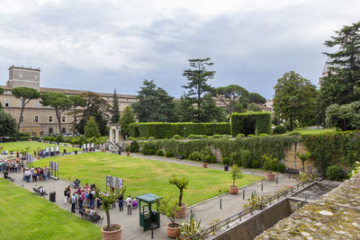 Tourists on an excursion in beautiful vatican gardens, rome, italy.