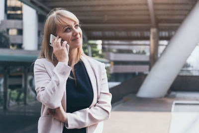 Mid adult woman using mobile phone